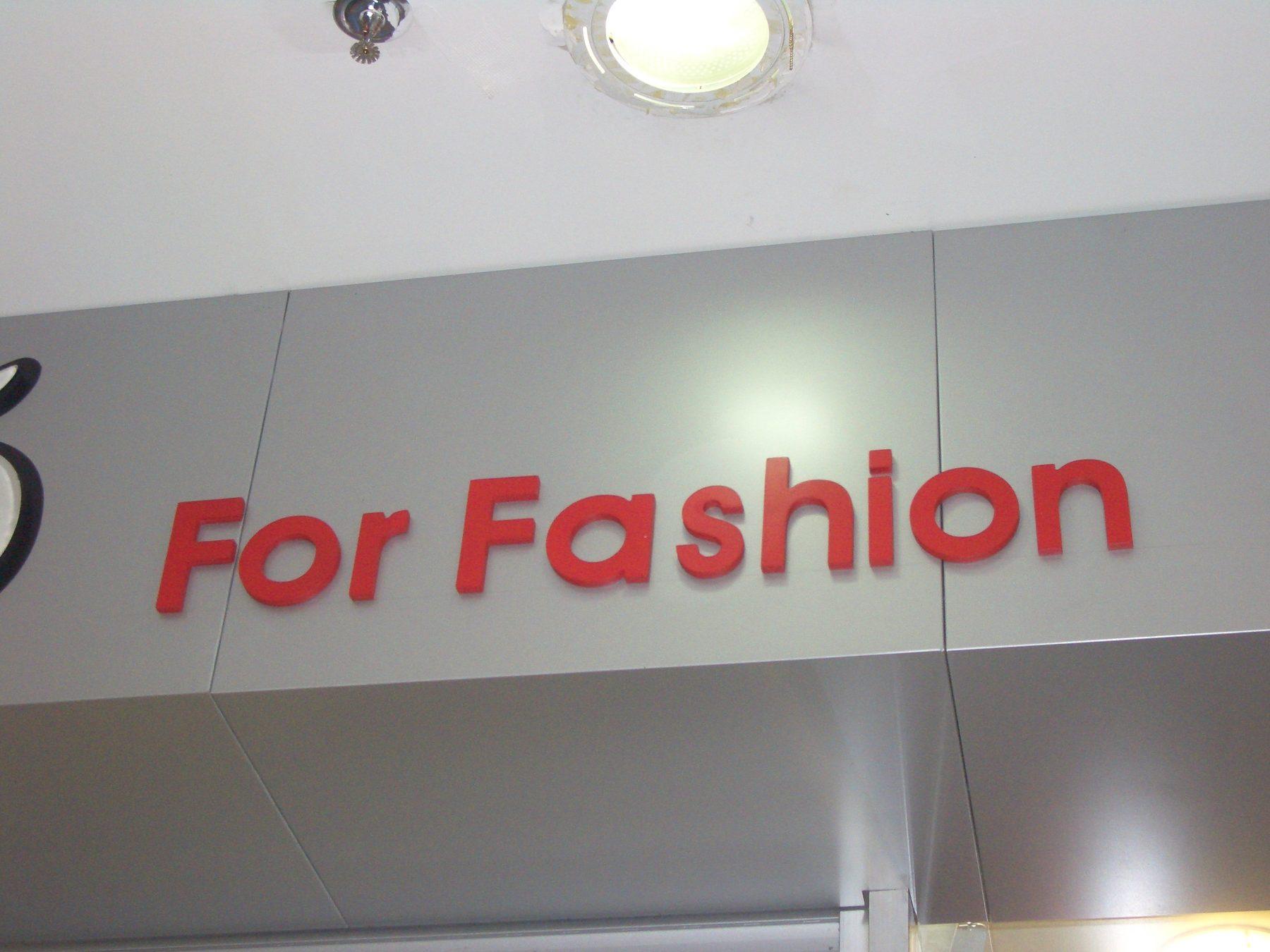 Close view of red dimensional lettering on a grey panel